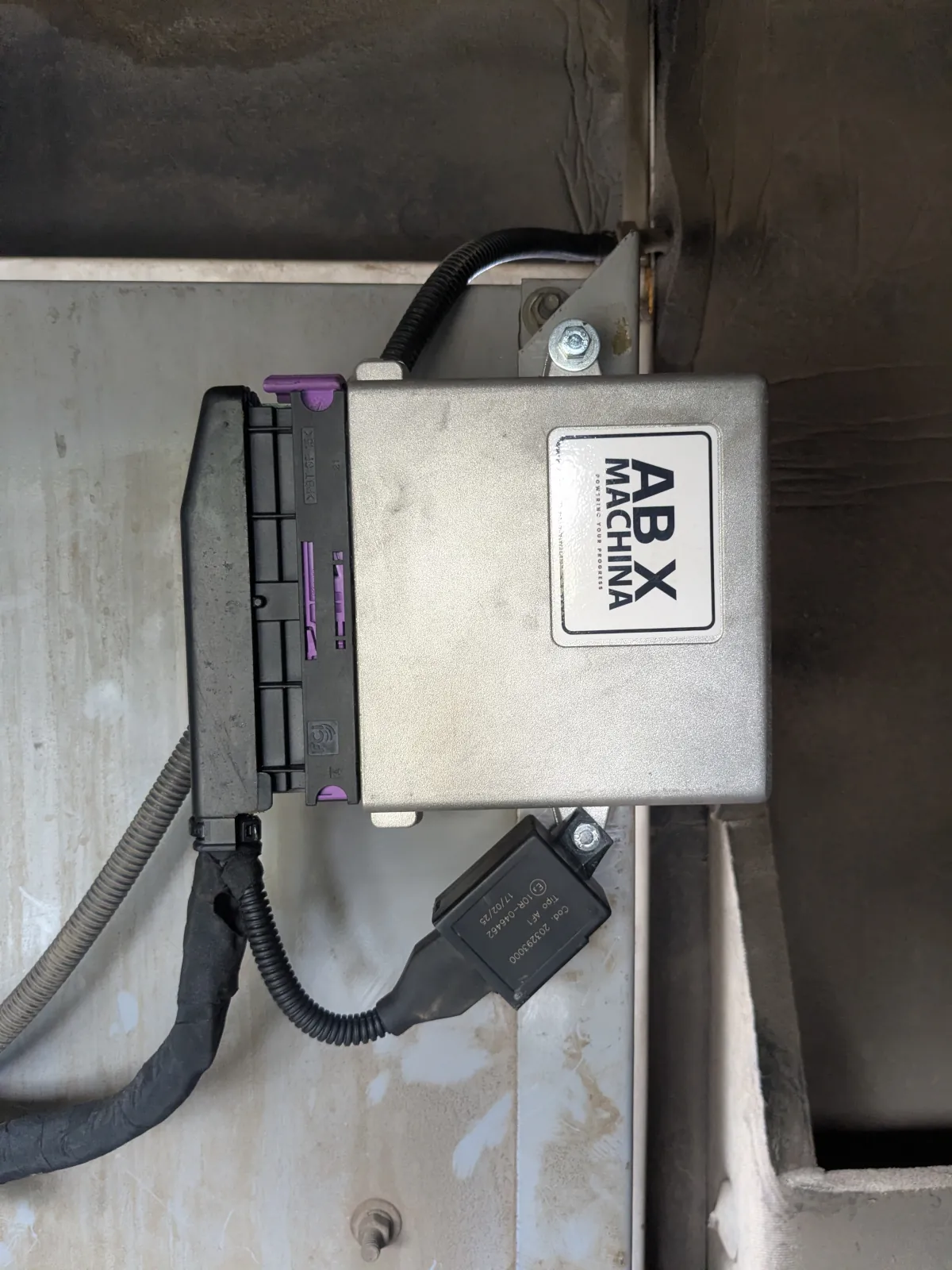 ABX electronic control unit and wiring hardware held during field inspection