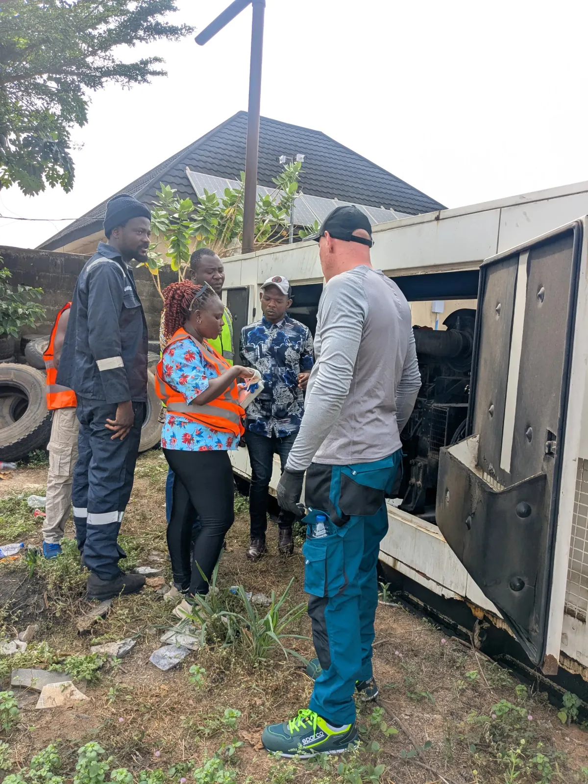 TEN technicians inspecting a generator and vehicle system before conversion